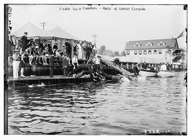 "Coney Island Carnival: swimming race in street clothing." Taken between 1910 and 1915.